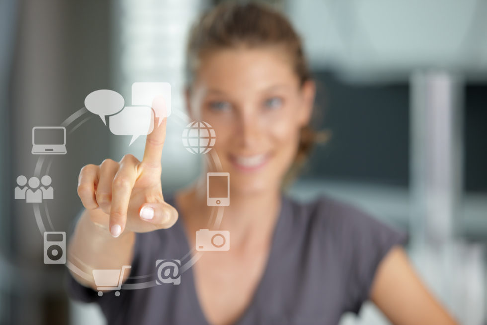 Smiling woman  pressing  touch screen on social network icon