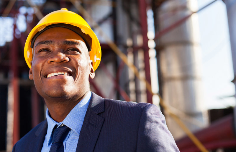 happy african industrial manager at oil refinery plant